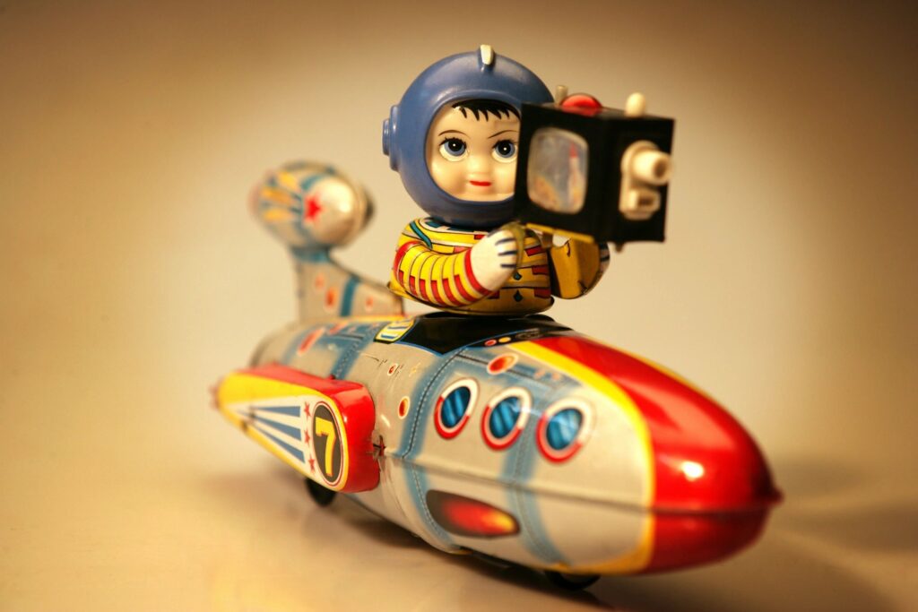 Toy figurine of an astronaut in a rocket ship.